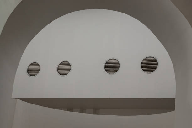 istock Sunlight shines through white arch interior design and white cement wall. 1706986728