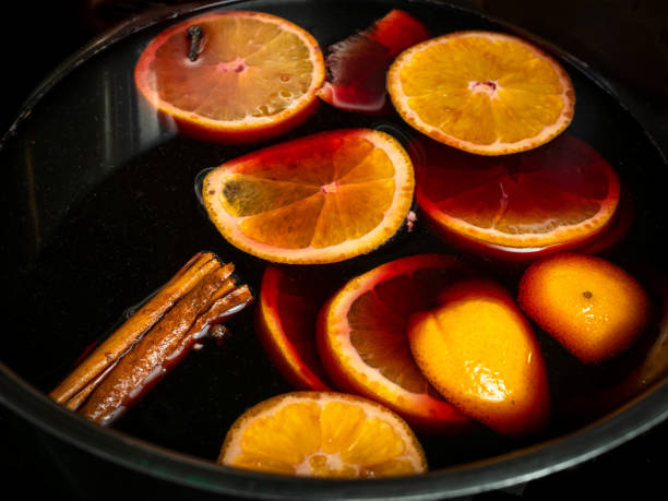 Traditional Swedish Christmas drink, called Glogg, similar to Gluhwein, here being prepared with red wine, oranges and cinnamon. stock photo
