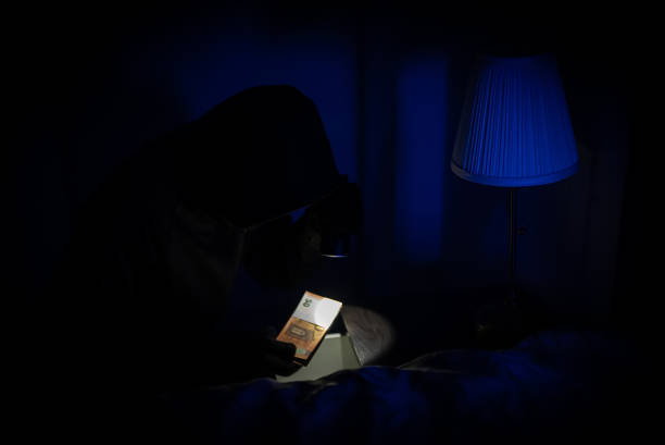 istock Female thief steals money from the bedside table. 1706992406