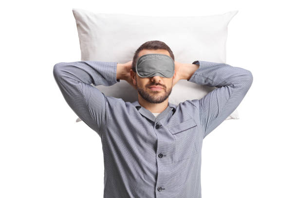 istock Man in pajamas wearing a mask and sleeping on a pillow 1706992902