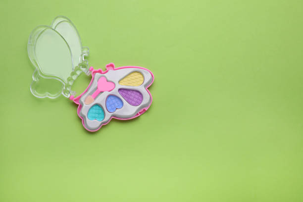 istock Decorative cosmetics for kids. Eye shadow palette on light green background, top view. Space for text 1707029256