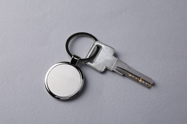istock Key with metallic keychain on light grey background, top view 1707035935