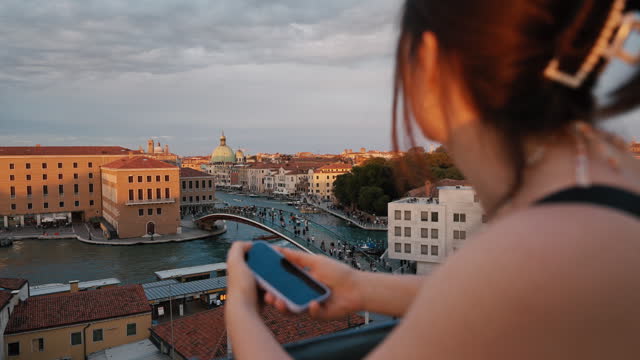 SLO MO Beautiful Tourist with Smartphone Watching Arch Bridge over Grand Canal near Buildings in Venice