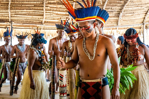 Manaus, Brazil - 08-30-2023: Native amazon indigenous people performing ritual dance in traditional costumes in village