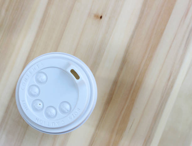 istock White coffee lid on wood background 1707040557
