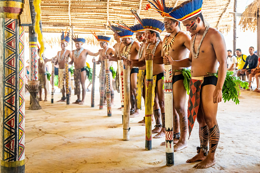 Manaus, Brazil - 08-30-2023: Native amazon indigenous people performing ritual dance in traditional costumes in village