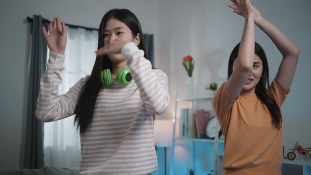 Group of Young Women Enjoy to practice dancing through smartphone at Home