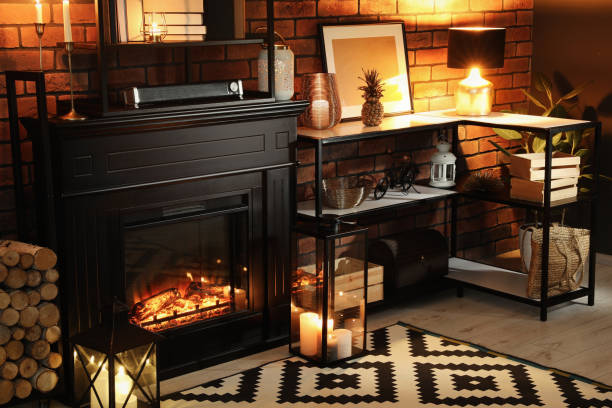 istock Beautiful fireplace and different decor in living room at night. Interior design 1707045897