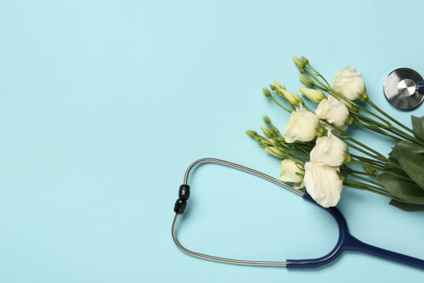 istock Stethoscope and beautiful eustoma flowers on light blue background, flat lay with space for text. Happy Doctor's Day 1707045954