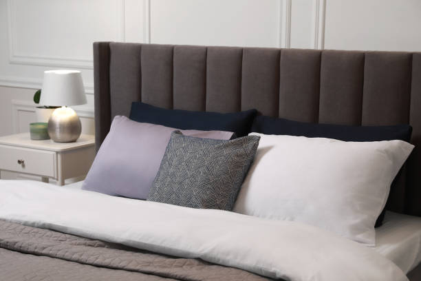 istock Comfortable bed with pillows and bedding in stylish room. Interior design 1707046000