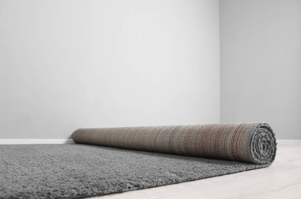 istock Rolled grey carpet on floor in room, closeup 1707046027