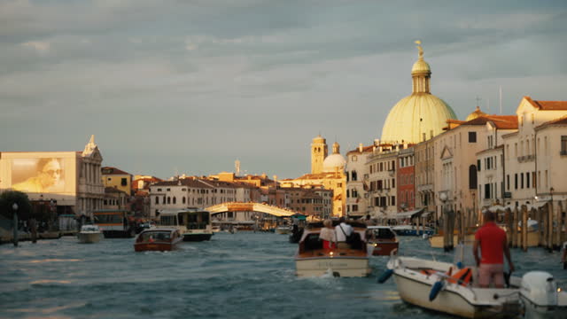 SLO MO Tourboats Moving on Grand Canal amidst Buildings in Venice under Cloudy Sky