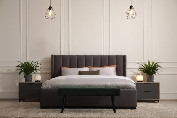 istock Stylish bedroom interior with large comfortable bed and ottoman 1707046141