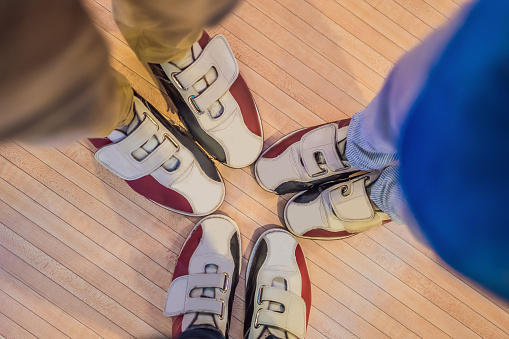 Family in bowling shoes. Family time together.