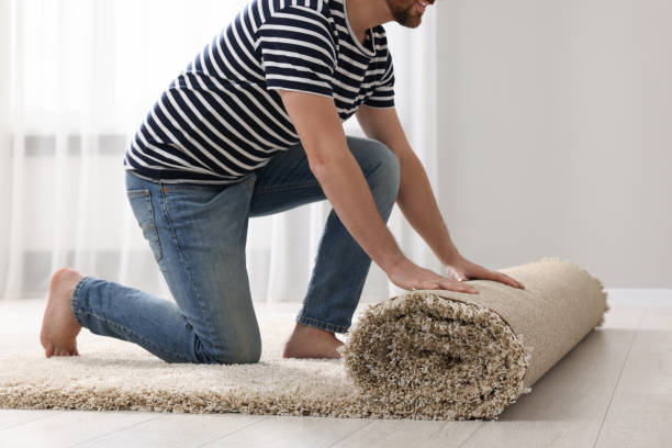 istock Man unrolling carpet on floor in room, closeup 1707082267