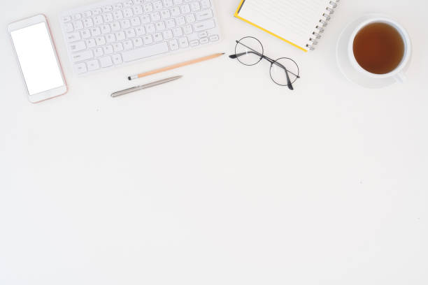 istock Top view above of white office desk table with keyboard notebook and coffee cup with equipment other office supplies. business and lifestyle concept with blank copy space 1707091880