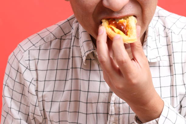 istock Man Eating Food 1707125525