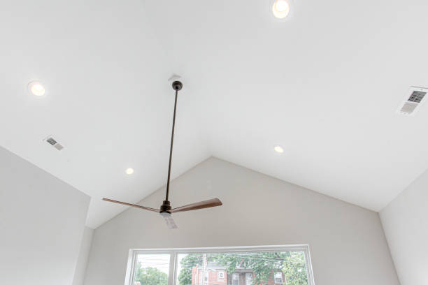 istock Stylish Modern Wood and Black Ceiling Fan with Vaulted Ceiling and Expansive Modern Window 1707137755