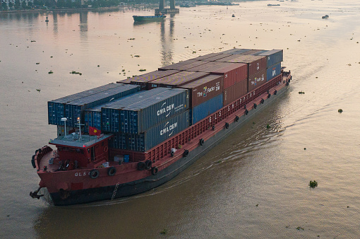 Aerial photo of cargo ship sailing on Tien River and Rach Mieu bridge, My Tho city, Tien Giang province