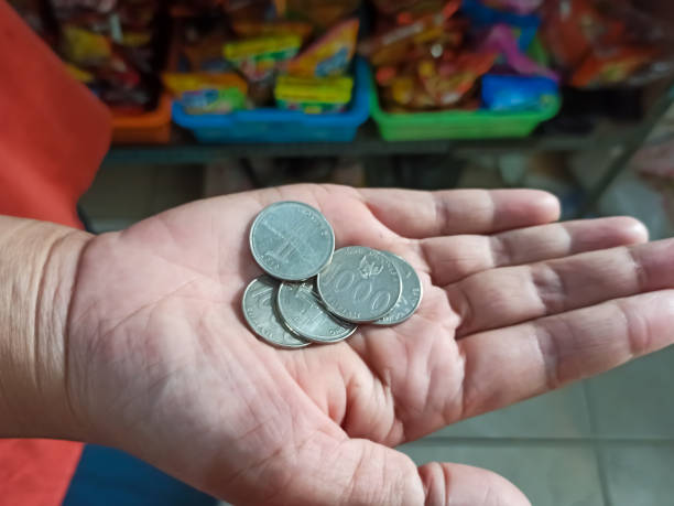 Currency in Hand: Woman Showcasing Her Coin Collection Witness the fascinating world of numismatics as a woman showcases her coin collection, each piece holding a unique story. cara mendapatkan chip gratis tiap hari stock pictures, royalty-free photos & images