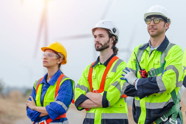 istock Teamwork engineer wearing safety uniform standing crossed arms at wind turbine field renewable energy. technology protect environment reduce global warming problems. alternative energy concept. 1707192229