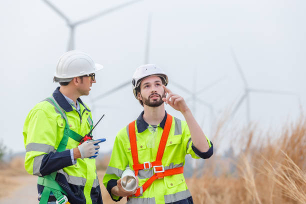 istock Teamwork engineer worker wearing safety uniform discuss operational planning at wind turbine field renewable energy. technology protect environment reduce global warming problems. 1707193337