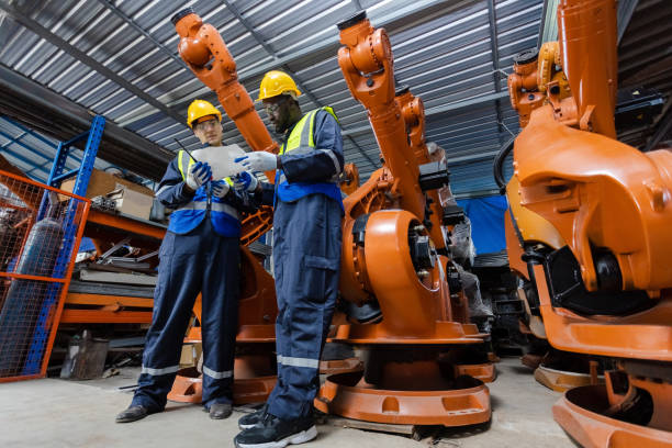 istock engineer team worker standing at automation robot arms machine in factory. technician maintenance robotic workshop. 1707196097