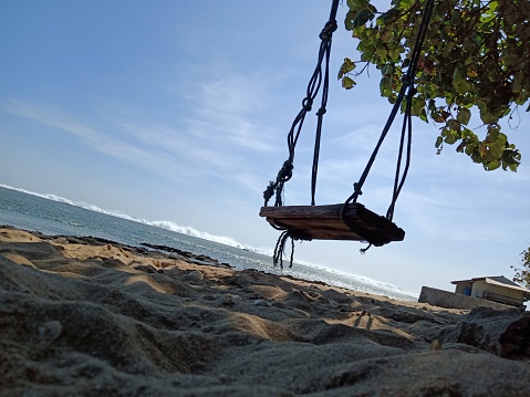 Wooden swings installed on the beach was taken in landscape