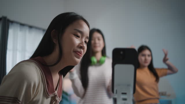 Group of Young Women Enjoy to practice dancing through smartphone at Home