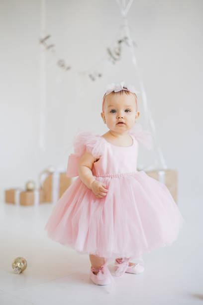 istock Little girl standing in studio with decorations for birthday 1707256472