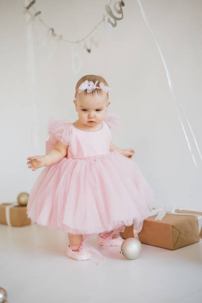 istock Little girl standing in studio with decorations for birthday 1707256481