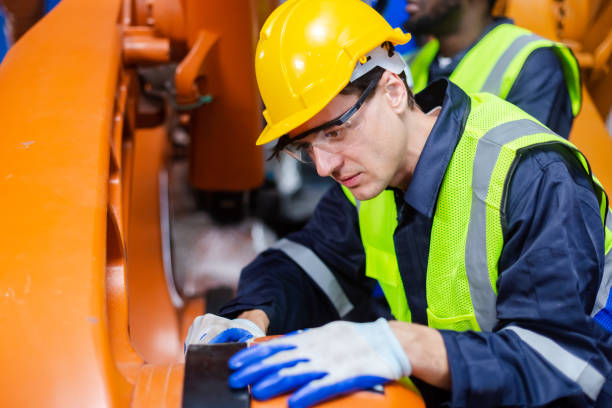 istock Male technician engineer checking automation robotics arm at industrial modern factory. man working at factory innovation automation robot. 1707256724