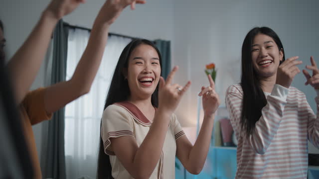 Group of Young Women have fun to practice dancing through smartphone at Home