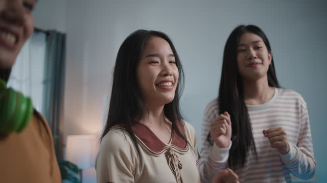 Group of Young Women have fun to practice dancing through smartphone at Home