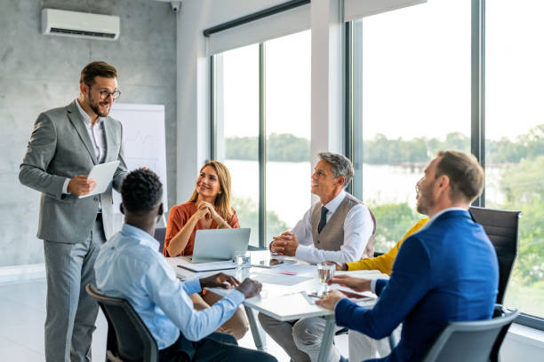 istock Young businessman talking to his colleagues in office at work. 1707278936