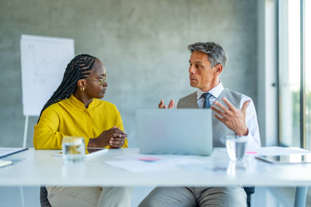 istock Business professionals sitting in an office and using a laptop 1707281315