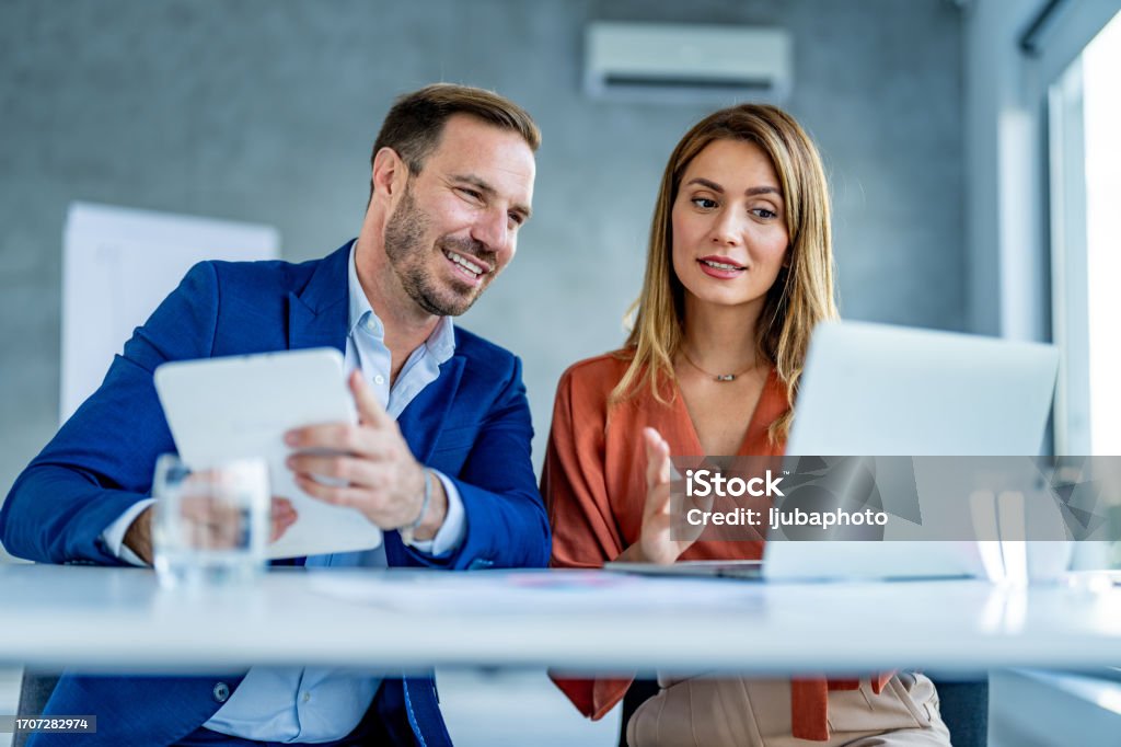 Small business owner training new employee on the job Business Stock Photo