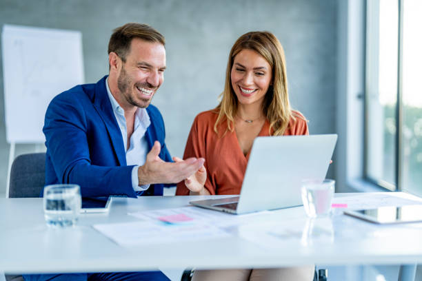 istock Two business people discussing business strategy using laptop. 1707283493