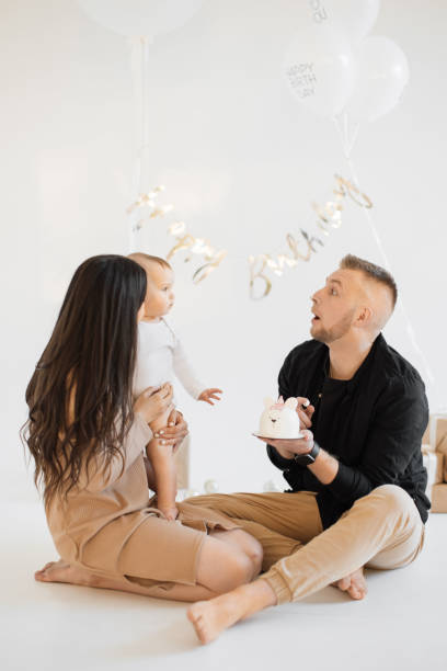 istock Caring parents greeting daughter with birthday cake indoors 1707304641