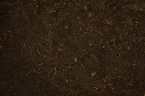 Overhead shot of brown dirt texture background.
