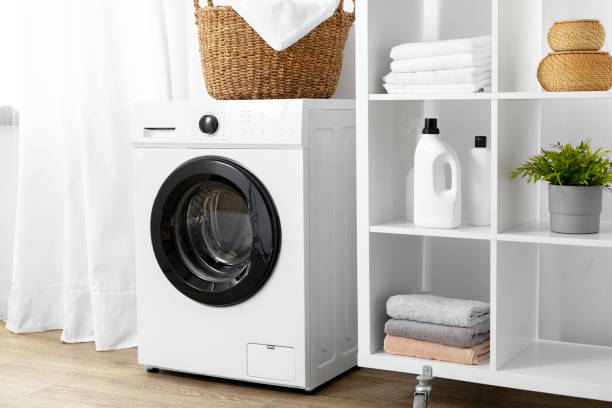 istock Modern white washing machine in a laundry room 1707341567