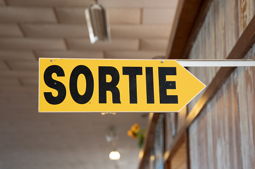 sortie french text means exit sign with yellow black arrow indicating evacuation outdoor