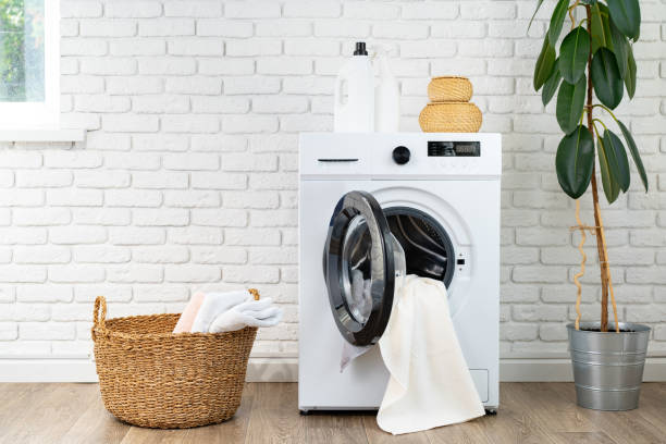 istock Washing machine and basket in a laundry room 1707355413