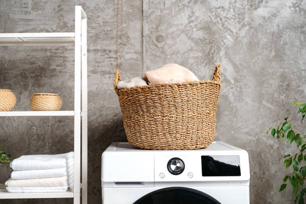 istock Laundry room interior with washing machine near gray grunge wall 1707372430