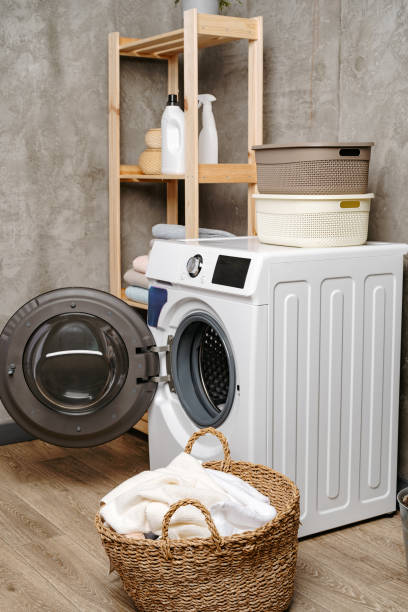 istock Laundry room interior with washing machine near gray grunge wall 1707372431