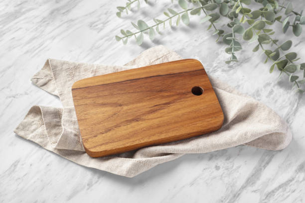 istock Wooden borad with linen napkin on white marble kitchen table 1707381454