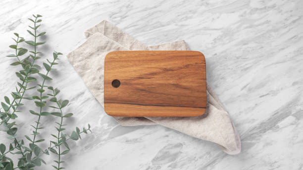 istock Wooden board with linen napkin on marble kitchen table 1707381478