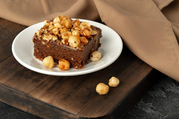 istock Brownie cake with nuts topping on plate close up 1707385403