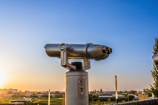 Old coin telescope looking over paris cityscape \nParis, France