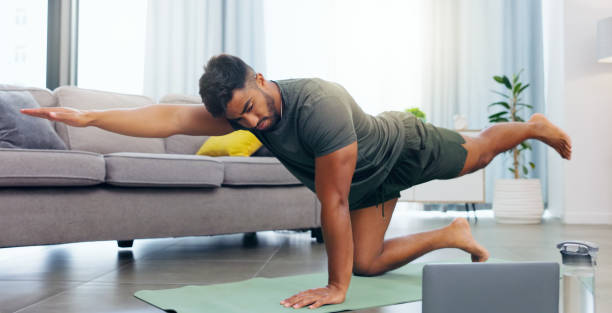 istock Yoga, calm and a man doing meditation from a laptop for relaxation, exercise and mindfulness. Morning, fitness and a guy stretching while listening to calming music and following a tutorial on a pc 1707414205